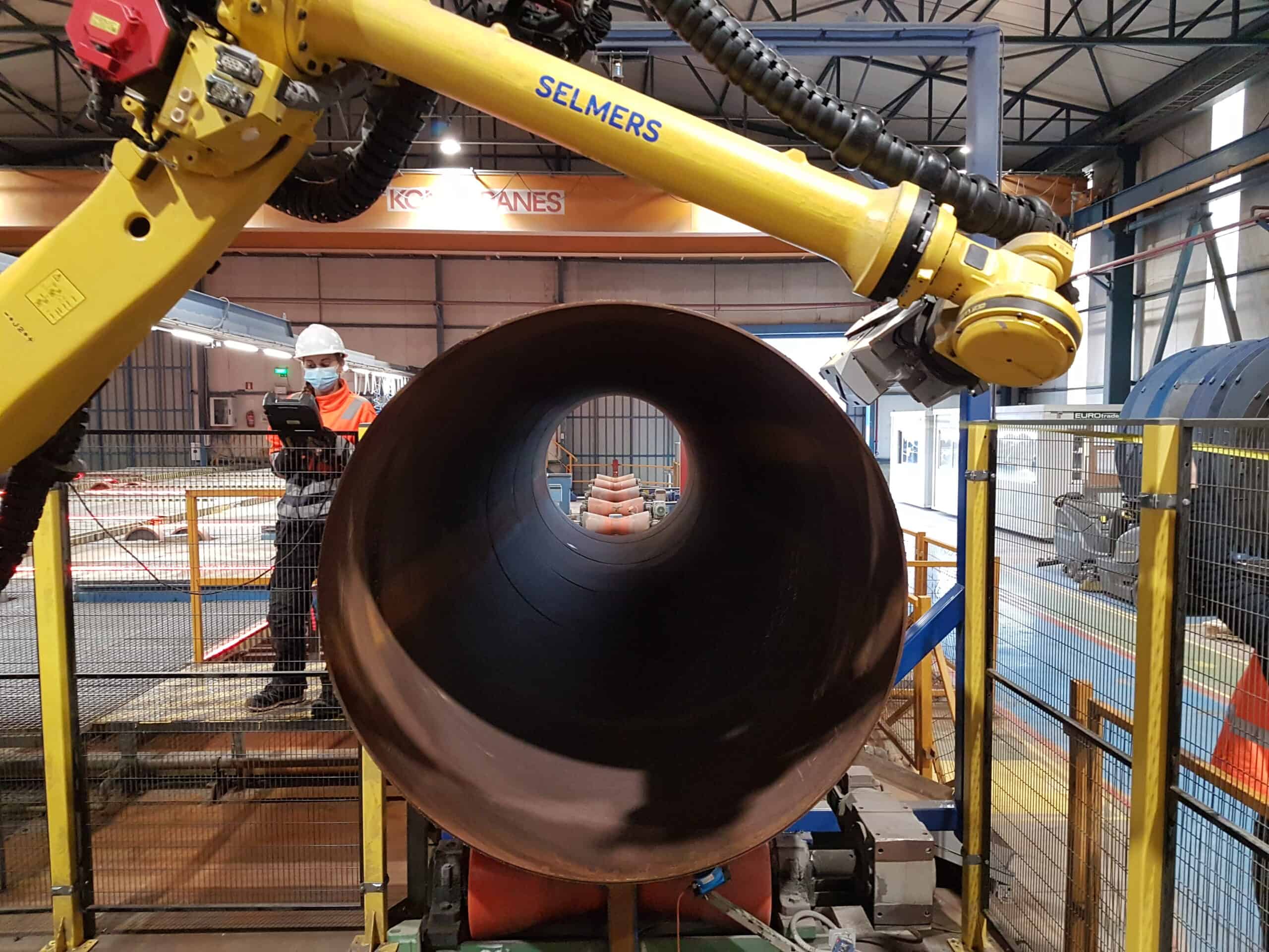 inside of a steel pipe with robot arm above it